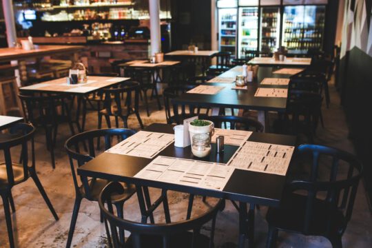 Backflow Prevention: Ultimate Guide for Restaurants | Tables and chairs in casual modern restaurant | SLM Facilities