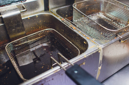 Fryers in restaurant | Troubleshoot Common Causes of Grease Interceptors Backing Up | SLM Facilities