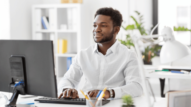 young, african american working on computer Outsourcing Facility Maintenance